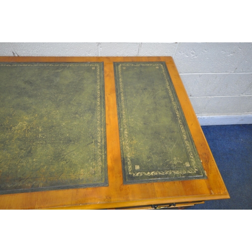 202 - A 20TH CENTURY YEW WOOD TWIN PEDESTAL DESK, with green leather writing surface, fitted with eight as... 