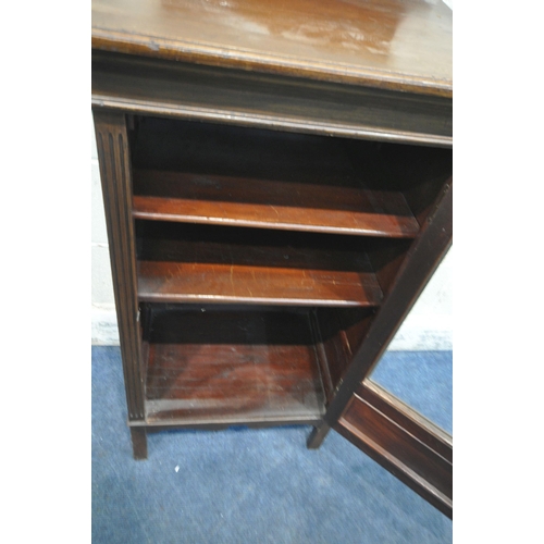 216 - A 20TH CENTURY MAHOGANY MUSIC CABINET, with a raised back, the single glass door enclosing shelves, ... 