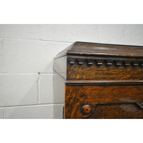 221 - A 20TH CENTURY OAK DOUBLE DOOR WARDROBE, with foliate and geometric carved details, a fitted interio... 