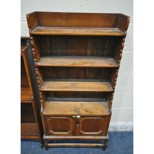 228 - TWO 20TH CENTURY OAK BOOKCASES, the larger bookcase with double cupboard doors, width 69cm x depth 2... 