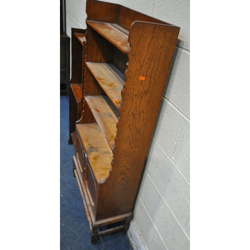 228 - TWO 20TH CENTURY OAK BOOKCASES, the larger bookcase with double cupboard doors, width 69cm x depth 2... 