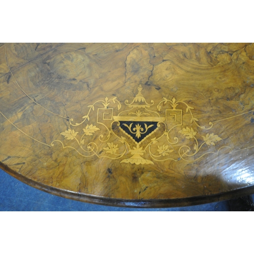 232 - A 20TH CENTURY BURR WALNUT OVAL TILT TOP TABLE, raised on a base with four pillars, and four scrolle... 