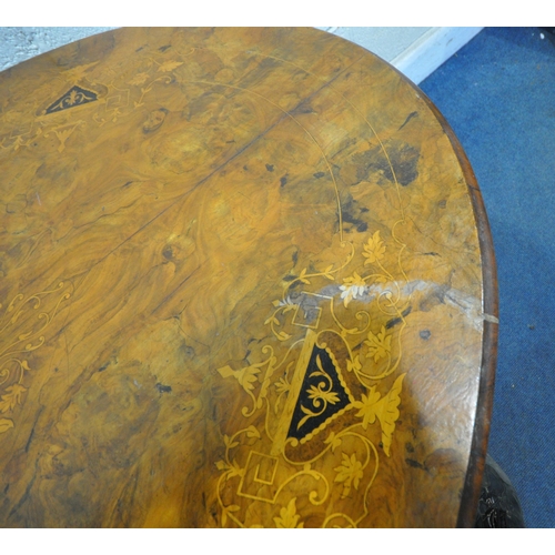 232 - A 20TH CENTURY BURR WALNUT OVAL TILT TOP TABLE, raised on a base with four pillars, and four scrolle... 