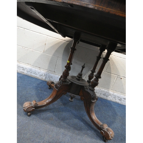 232 - A 20TH CENTURY BURR WALNUT OVAL TILT TOP TABLE, raised on a base with four pillars, and four scrolle... 