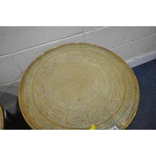 241 - TWO CIRCULAR BRASS TRAY TOP TABLES, with intricate designs, raised on folding bases, tallest table d... 