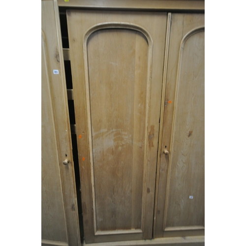 251 - A 19TH CENTURY PINE TRIPLE DOOR WARDROBE, with an overhanging, the right hand door enclosing various... 