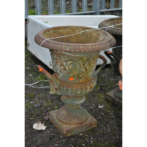 10 - A PAIR OF EARLY 20th CENTURY CAST IRON GARDEN URNS, with lion mask handles, foliate detail to bowl a... 