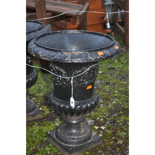 6 - A PAIR OF EARLY 20th CENTURY CAST IRON URNS, with foliate detail and fluted bowl height 47cm (2)