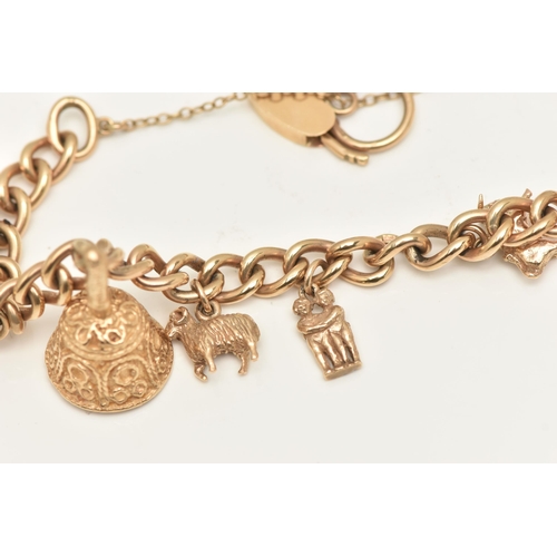 402 - A 9CT GOLD CHARM BRACELET, a yellow gold curb link bracelet, fitted with a heart padlock clasp, hall... 