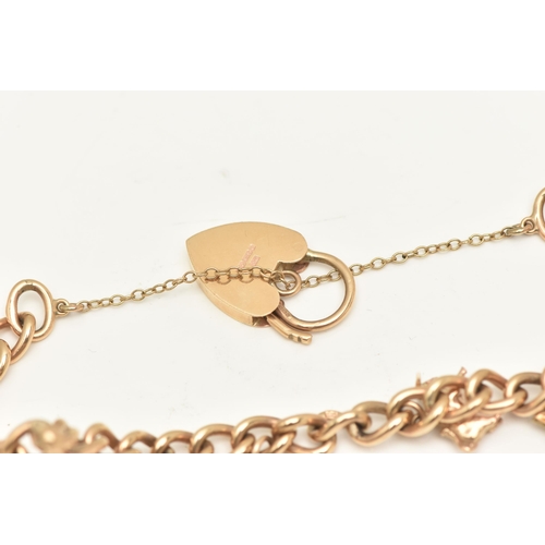 402 - A 9CT GOLD CHARM BRACELET, a yellow gold curb link bracelet, fitted with a heart padlock clasp, hall... 