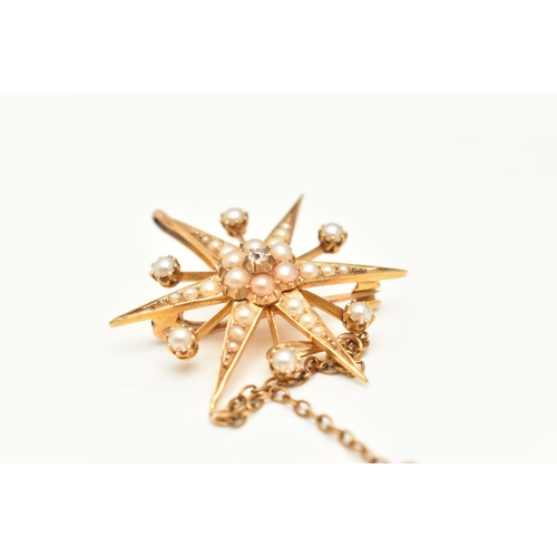 414 - AN EARLY 20TH CENTURY PEARL AND DIAMOND CELESTIAL BROOCH, designed as a yellow metal star, set with ... 