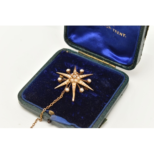 414 - AN EARLY 20TH CENTURY PEARL AND DIAMOND CELESTIAL BROOCH, designed as a yellow metal star, set with ... 