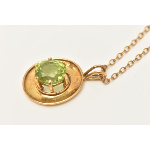 419 - A YELLOW METAL PERIDOT PENDANT, an oval cut peridot, prong set in yellow metal with a wide yellow me... 