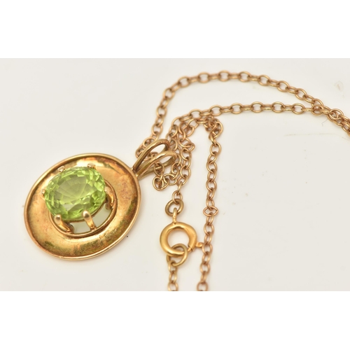 419 - A YELLOW METAL PERIDOT PENDANT, an oval cut peridot, prong set in yellow metal with a wide yellow me... 