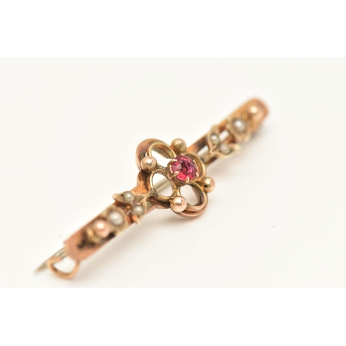 421 - AN EARLY 20TH CENTURY BAR BROOCH, circular cut red paste centrally set in a yellow metal quatrefoil ... 