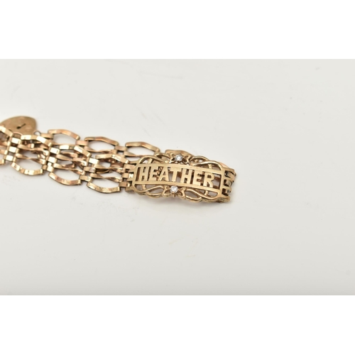 426 - A 9CT GOLD GATE NAME BRACELET, a yellow gold gate bracelet, fitted with a central panel with the nam... 