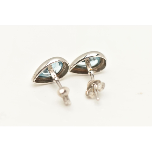 428 - A PAIR OF WHITE METAL BLUE TOPAZ STUD EARRINGS, each earring of a pear shape set with a pear cut blu... 