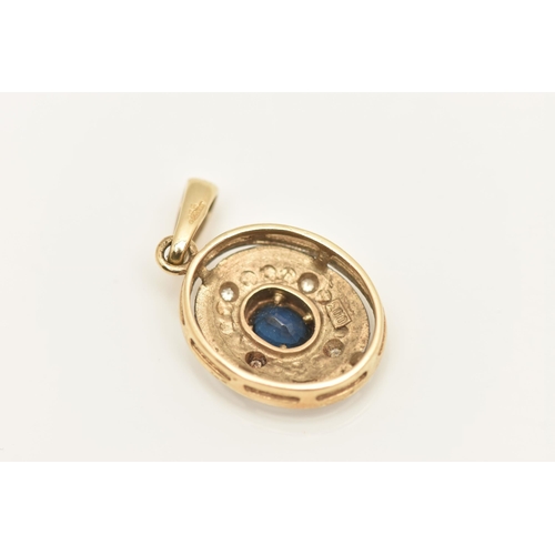 432 - A 9CT GOLD SAPPHIRE AND DIAMOND PENDANT, of an oval form, set with an oval cut deep blue sapphire ce... 