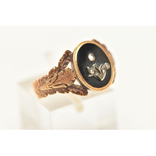 440 - A YELLOW METAL MEMORIAL RING, of an oval form set with an onyx inlay displaying leaves of a flower s... 