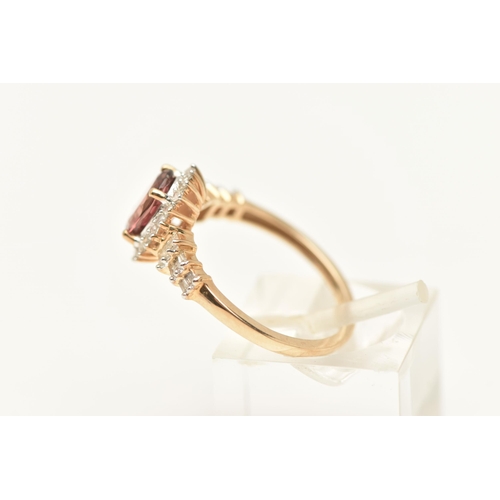 445 - A 9CT GOLD CLUSTER RING, of an oval form, set with an oval cut pinkish stone assessed as tourmaline,... 