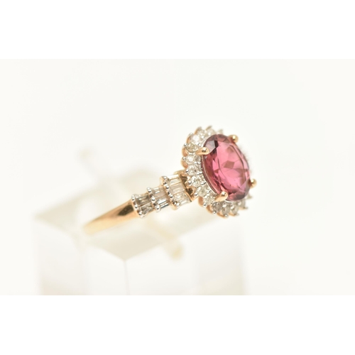 445 - A 9CT GOLD CLUSTER RING, of an oval form, set with an oval cut pinkish stone assessed as tourmaline,... 