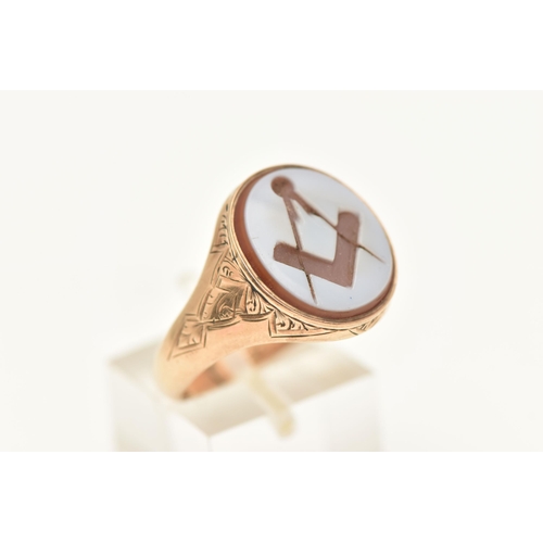 447 - A GENTS 9CT GOLD, MASONIC SIGNET RING, of an oval form, set with a carved sardonyx inlay depicting t... 