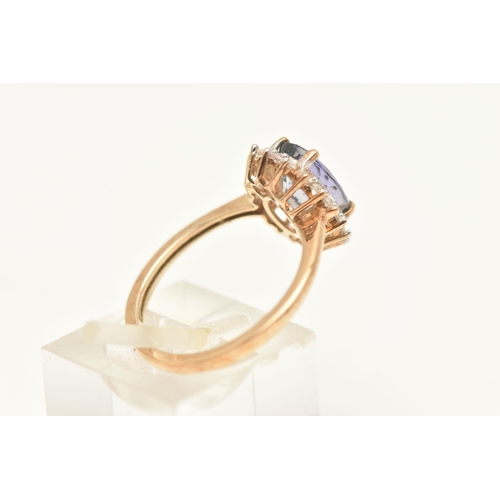 449 - A 9CT GOLD CLUSTER RING, of an oval form, set with an oval cut mystic topaz, four claw set within a ... 