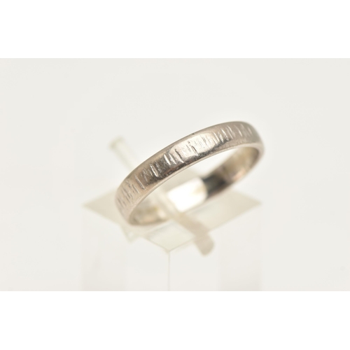 464 - A WHITE METAL BAND RING, with textured surface detail, stamped 18ct, ring size Q, approximate gross ... 