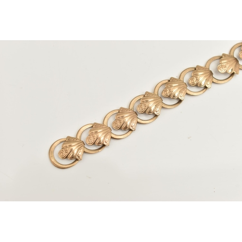 467 - A 9CT YELLOW GOLD BRACELET, designed as a series of scroll design links, with plain polished spacers... 