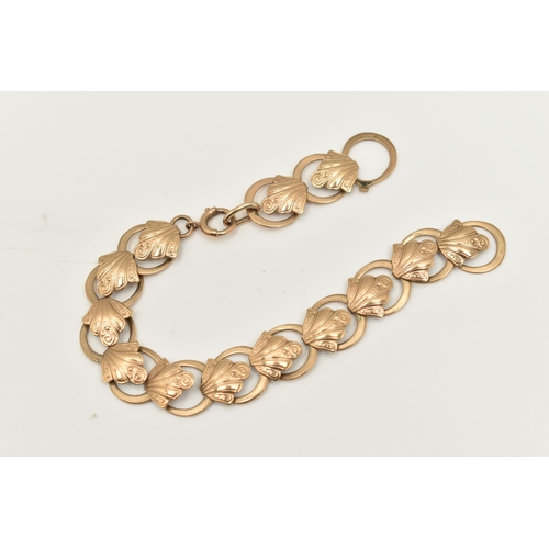 467 - A 9CT YELLOW GOLD BRACELET, designed as a series of scroll design links, with plain polished spacers... 