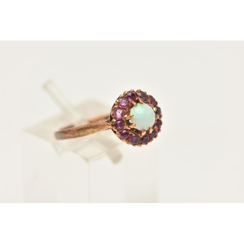 478 - A 9CT YELLOW GOLD OPAL AND RUBY CLUSTER RING, set with an opal cabochon, surrounded by rubies, to th... 