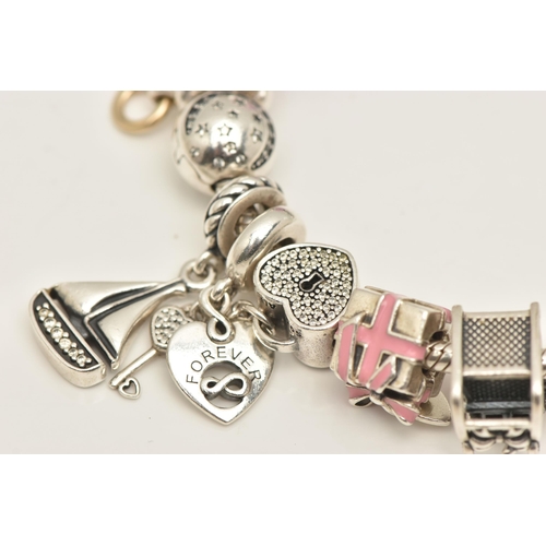 481 - A PANDORA CHARM BRACELET, to include a bracelet with fourteen charms and two hinged spacer charms, b... 