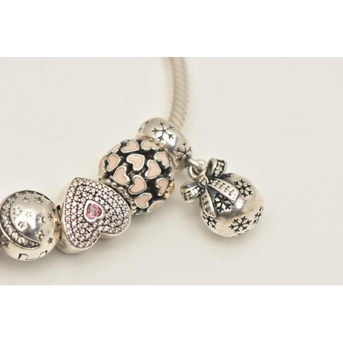 481 - A PANDORA CHARM BRACELET, to include a bracelet with fourteen charms and two hinged spacer charms, b... 