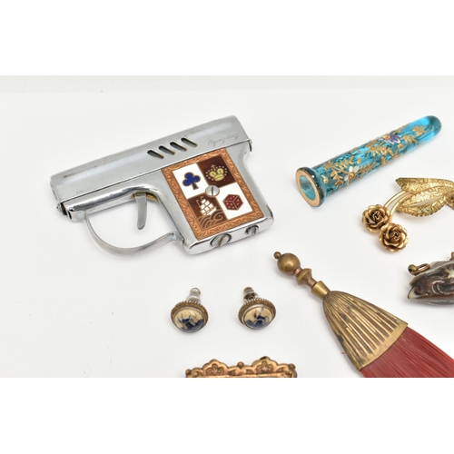 517 - A BAG OF ASSORTED ITEMS, to include a novelty gun lighter, five continental items including brooches... 