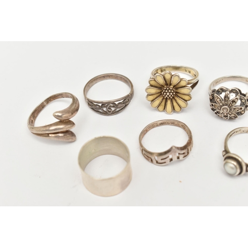 520 - A COLLECTION OF WHITE METAL RINGS, nine rings in total, to include a floral enamel ring, a split pea... 