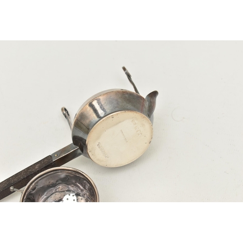 529 - A 'GARRARD & CO' SILVER TEA STRAINER, fitted with a wooden handle, hallmarked 'Garrard & Co Ltd' Lon... 