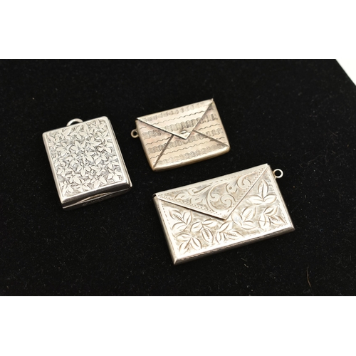 533 - TWO SILVER STAMP HOLDERS AND ONE OTHER, to include a silver foliate pattern double stamp holder, fit... 