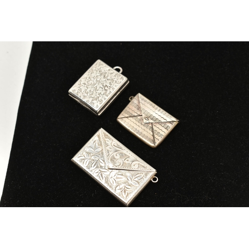 533 - TWO SILVER STAMP HOLDERS AND ONE OTHER, to include a silver foliate pattern double stamp holder, fit... 