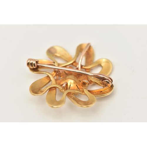 567 - A YELLOW METAL PEARL FLORAL BROOCH, open work floral design set with a central seed pearl and split ... 