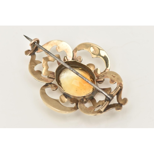 568 - A YELLOW METAL CITRINE BROOCH, open work brooch set with a central oval cut Citrine, collet set to t... 