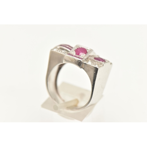 570 - A MID CENTURY RUBY AND DIAMOND RING, a white metal retro design ring set with one oval cut, two circ... 