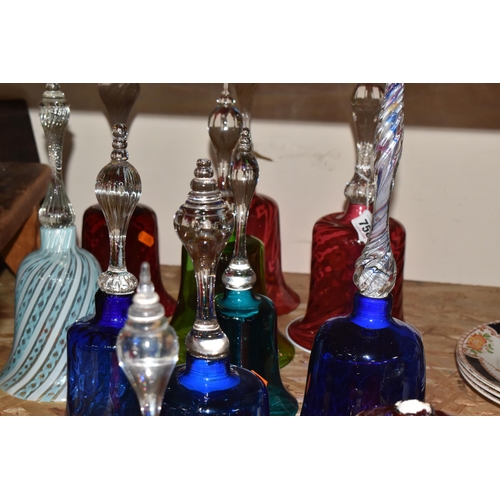 758 - A COLLECTION OF TWELVE COLOURED GLASS BELLS of assorted size and patterns with various handles and p... 