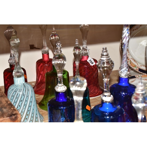 758 - A COLLECTION OF TWELVE COLOURED GLASS BELLS of assorted size and patterns with various handles and p... 