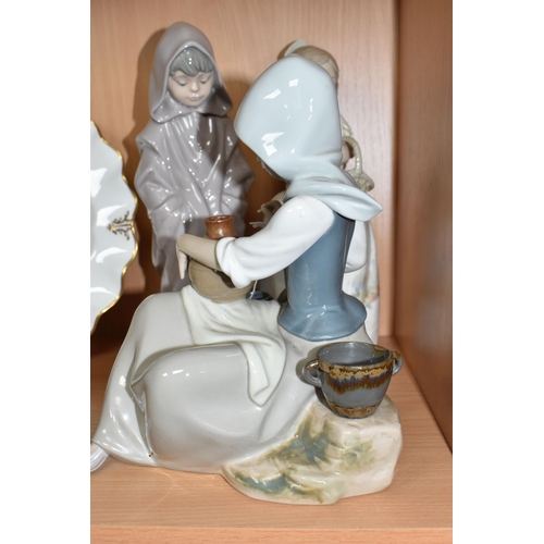 786 - A LLADRO FIGURE AND TWO NAO FIGURES, comprising Lladro Woman Painting no 5079, sculptor Juan Huerta,... 