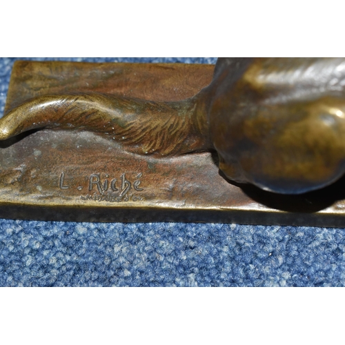 828 - AFTER LOUIS RICHÉ A BRONZED FIGURE OF A RECUMBENT GERMAN SHEPHERD DOG, on a rectangular base, signed... 