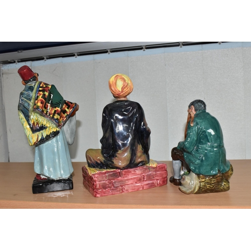 851 - THREE ROYAL DOULTON FIGURINES comprising 'Mendicant' HN1365, 'Carpet Seller' HN1464, and 'The Master... 