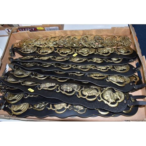 921 - ONE BOX OF VINTAGE BRASS HORSE MEDALLIONS ON LEATHER STRAPS, to include ten leather straps all with ... 