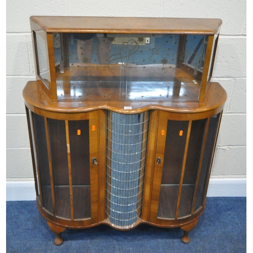 159 - A 20TH CENTURY WALNUT DRINKS CABINET, with double glass sliding doors, above two cupboard doors, fla... 