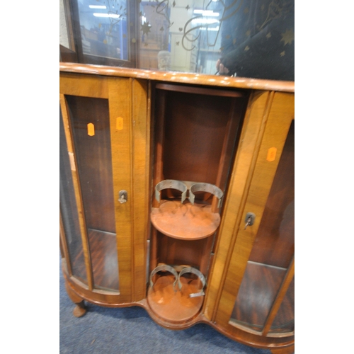 159 - A 20TH CENTURY WALNUT DRINKS CABINET, with double glass sliding doors, above two cupboard doors, fla... 