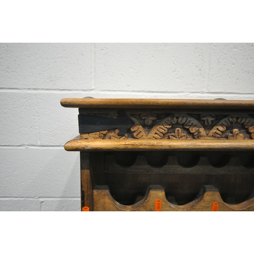 177 - AN EIGHTEEN SECTION HARDWOOD WINE RACK, with metal banding, repeating patterns, on bun feet, width 8... 